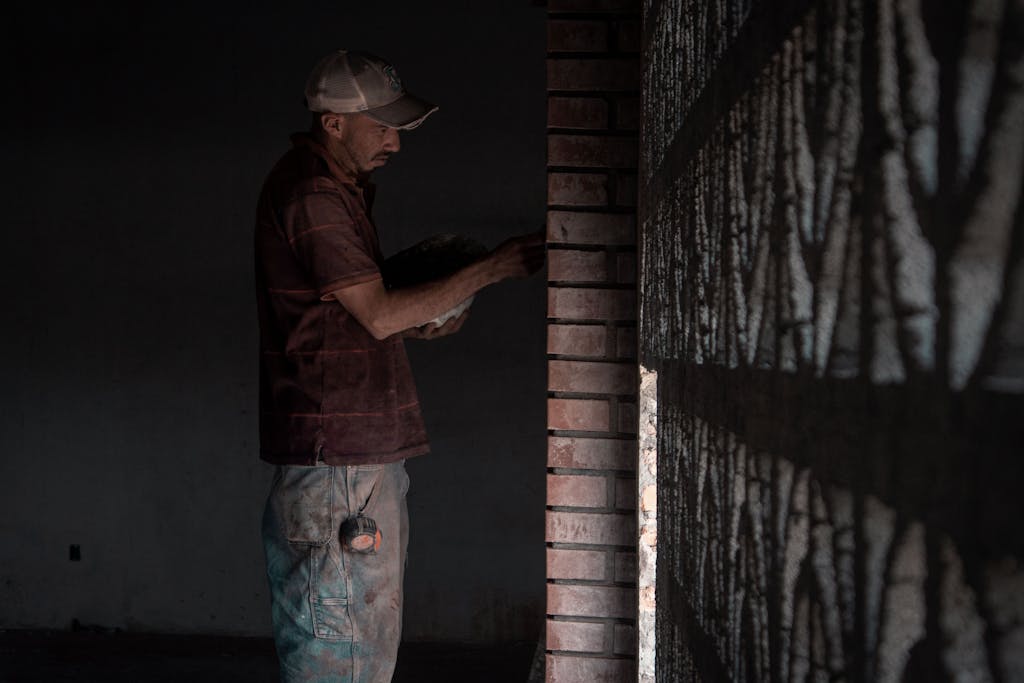 A Man doing Construction Work inside a Building