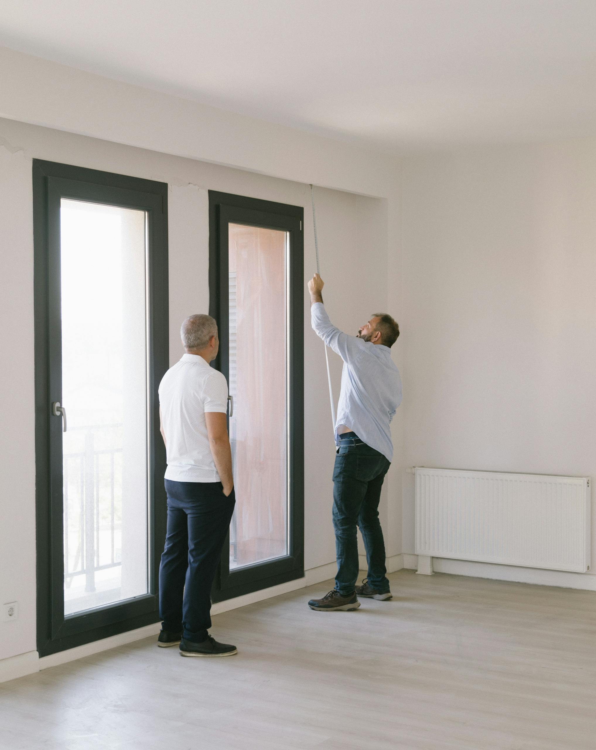 Men Measuring an Apartment